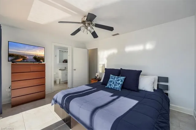 a bathroom with a granite countertop sink a toilet and a shower curtain