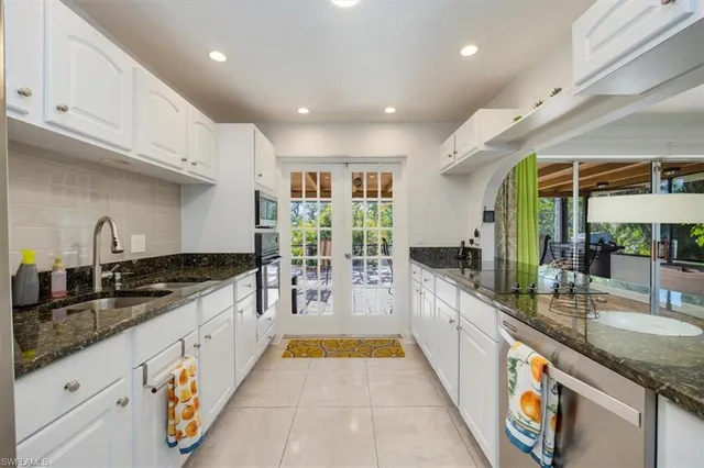 a bedroom with a bed and dresser with wooden floor