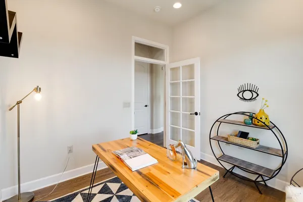 a spacious bedroom with a bed a couch and a window