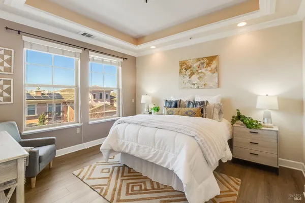 a spacious bedroom with a bed and a cabinets