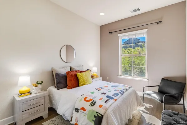 a bathroom with a granite countertop toilet a sink and mirror