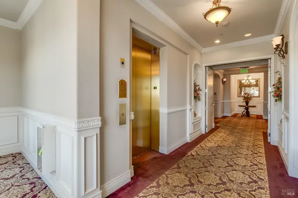 a kitchen with stainless steel appliances granite countertop a stove a refrigerator a kitchen island a dining table and chairs