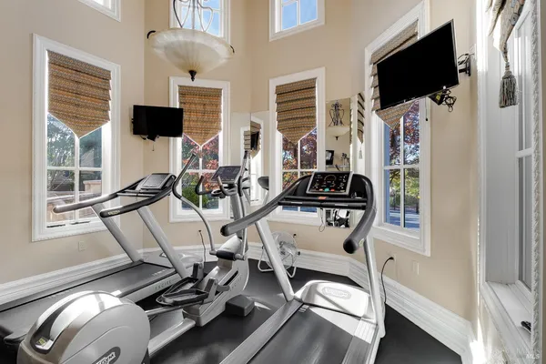 a living room with fireplace furniture and a chandelier