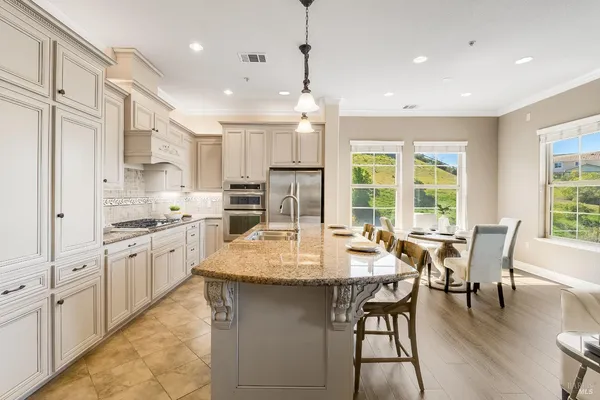 a kitchen with white cabinets and refrigerator