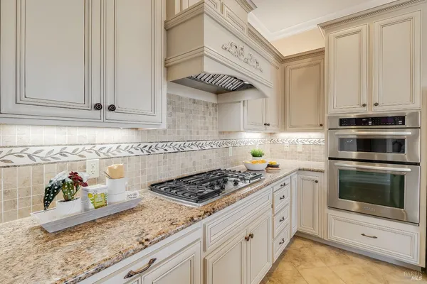 a living room with stainless steel appliances kitchen island granite countertop furniture and a large window