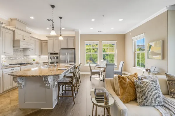 a large kitchen with a table and chairs