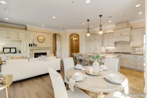 a living room with furniture a fireplace and a chandelier