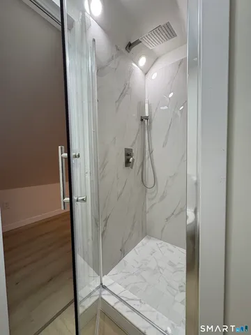 a bathroom with a granite countertop shower