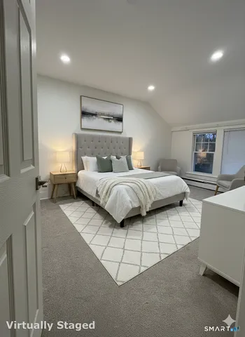 a bedroom with a bed and a night stand