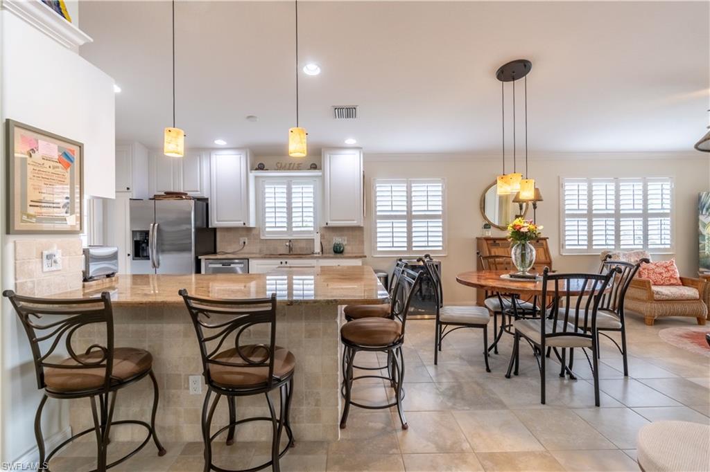7568 Novara Court Naples, FL 34114 - Photo 11 of 34 a view of a dining room with furniture and chandelier