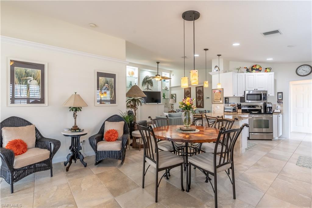 7568 Novara Court Naples, FL 34114 - Photo 16 of 34 a view of a dining room with furniture