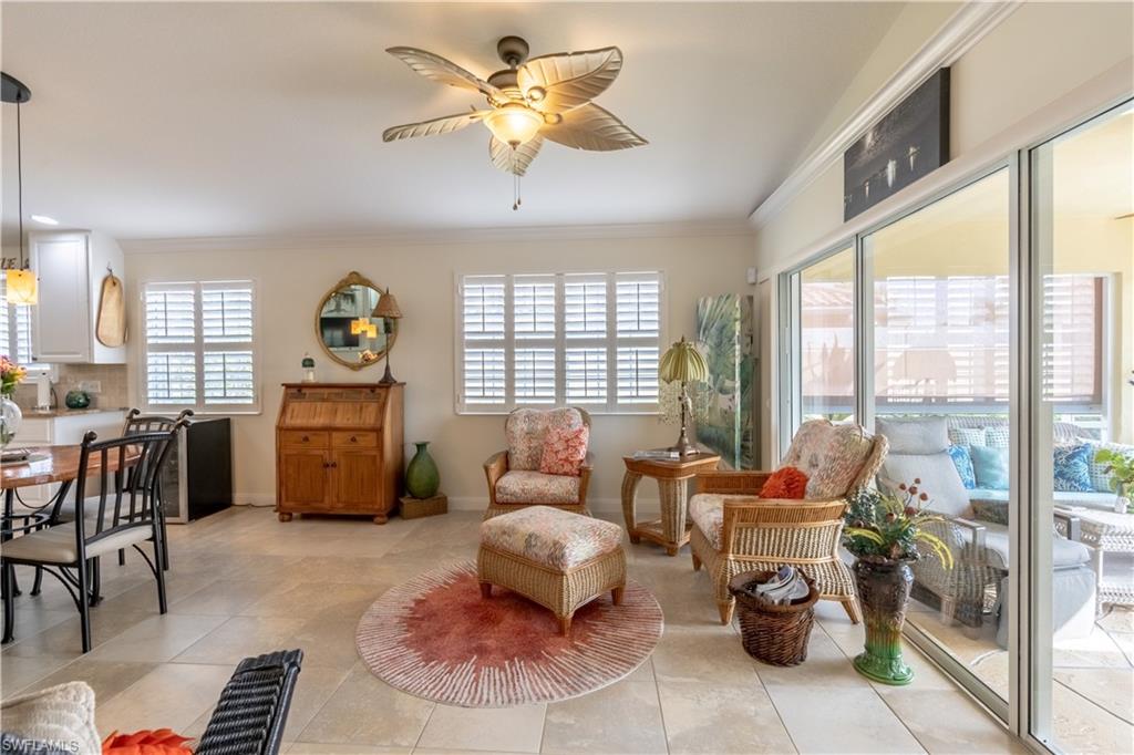 7568 Novara Court Naples, FL 34114 - Photo 19 of 34 a living room with furniture and a floor to ceiling window