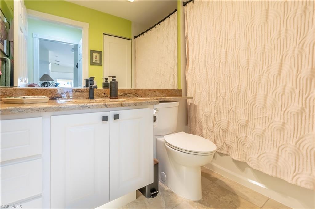 7568 Novara Court Naples, FL 34114 - Photo 20 of 34 a bathroom with a sink a toilet and a mirror