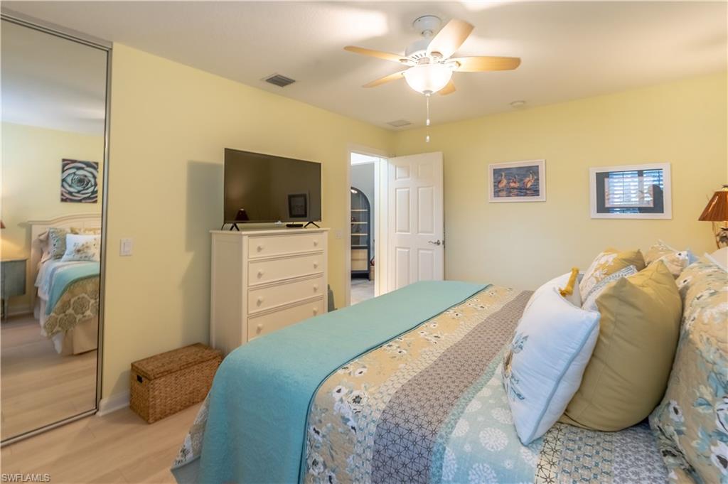 7568 Novara Court Naples, FL 34114 - Photo 22 of 34 a bedroom with a bed and a flat screen tv