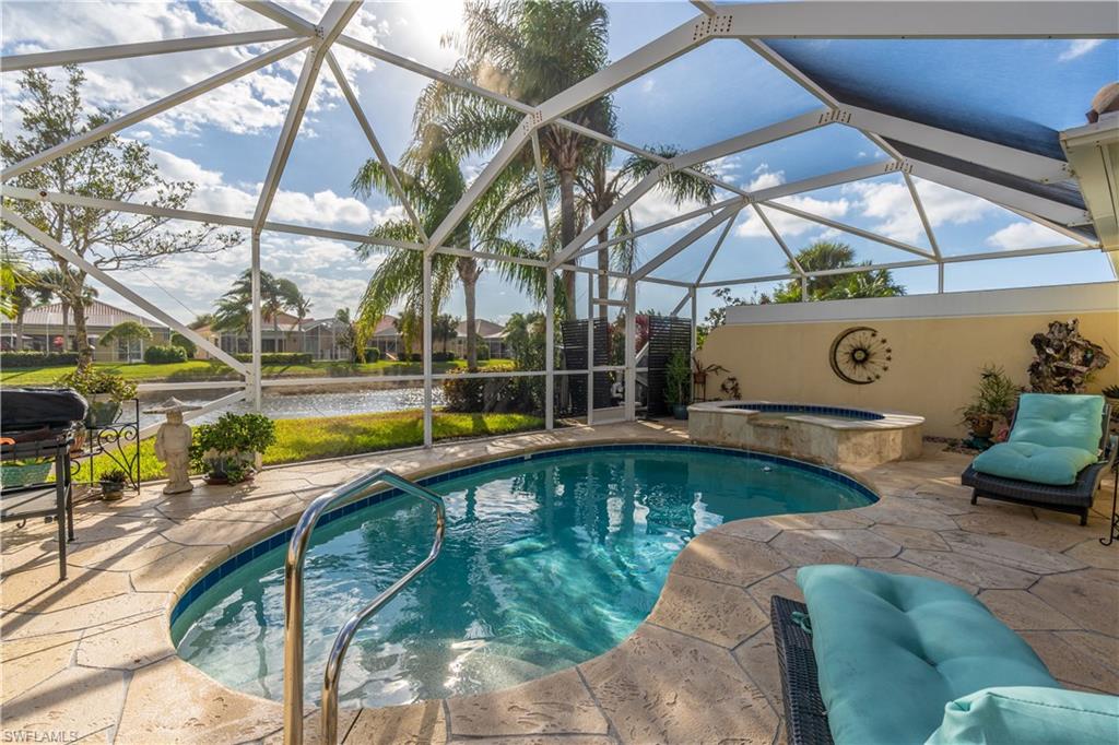 7568 Novara Court Naples, FL 34114 - Photo 29 of 34 a view of a swimming pool with a patio