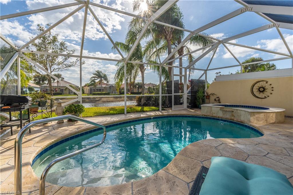 7568 Novara Court Naples, FL 34114 - Photo 30 of 34 a view of a swimming pool with a patio