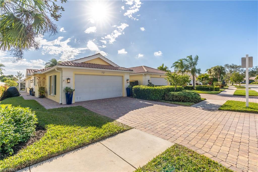 7568 Novara Court Naples, FL 34114 - Photo 3 of 34 a front view of a house with garden