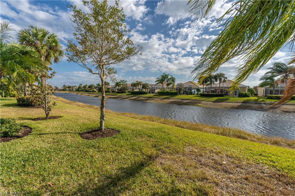 7568 Novara Court Naples, FL 34114 - Photo 34 of 34 a view of a swimming pool with an outdoor space and seating area