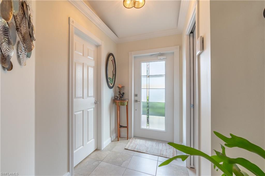 7568 Novara Court Naples, FL 34114 - Photo 6 of 34 a view of a bathroom from a corridor