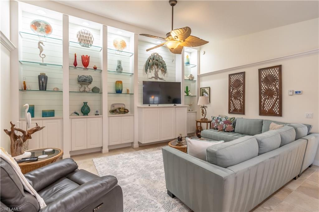 7568 Novara Court Naples, FL 34114 - Photo 8 of 34 a living room with furniture and a chandelier