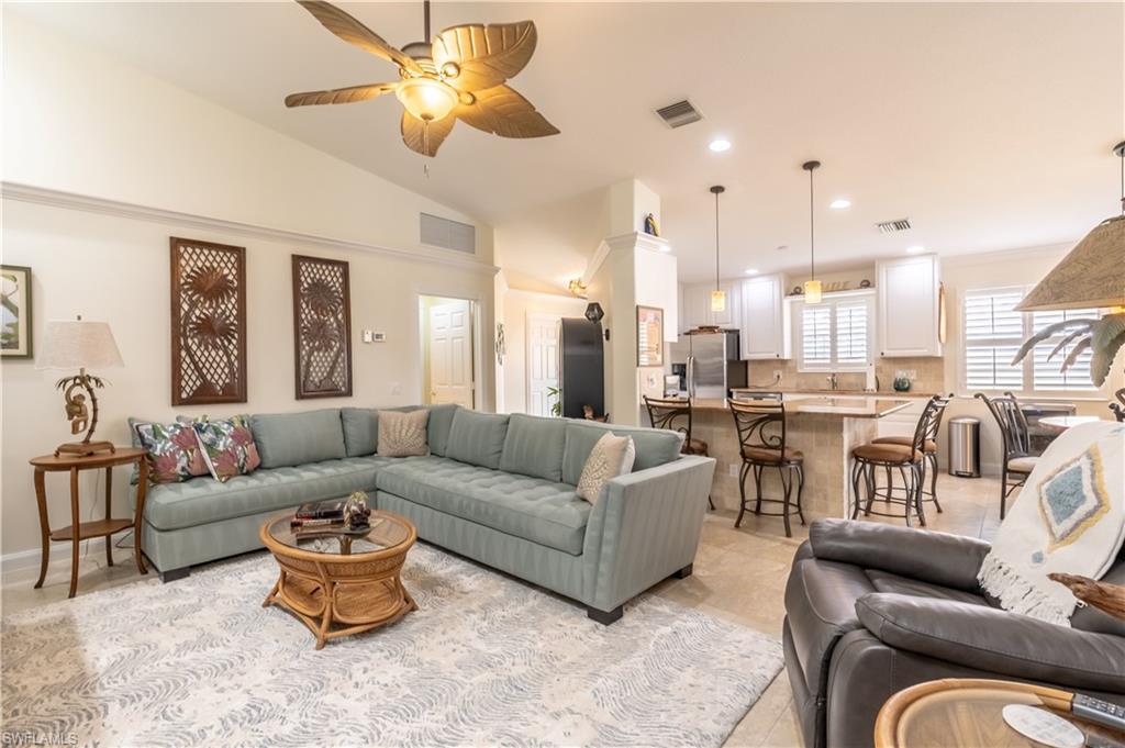 7568 Novara Court Naples, FL 34114 - Photo 9 of 34 a living room with furniture kitchen view and a chandelier