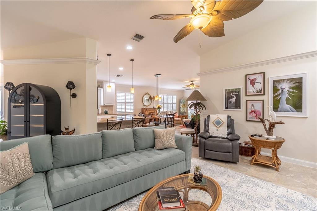 7568 Novara Court Naples, FL 34114 - Photo 10 of 34 a living room with furniture a rug and white walls