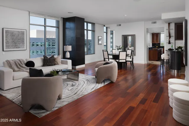 a living room with fireplace furniture and a wooden floor