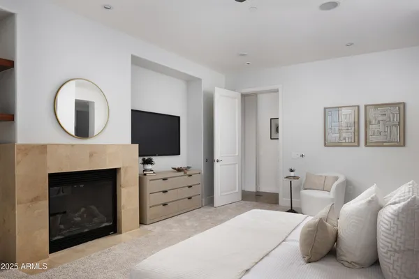 a bedroom with a bed and a fireplace