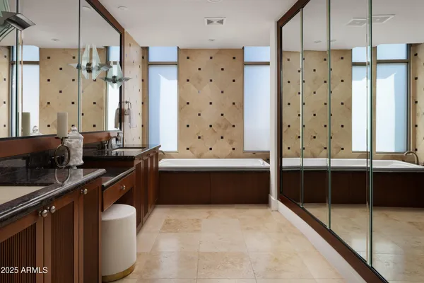 a large bathroom with a large tub and double sink