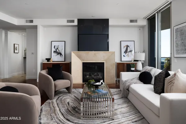 a living room with furniture a window and a fireplace