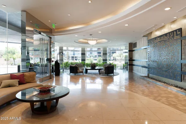 a lobby with furniture and a potted plant