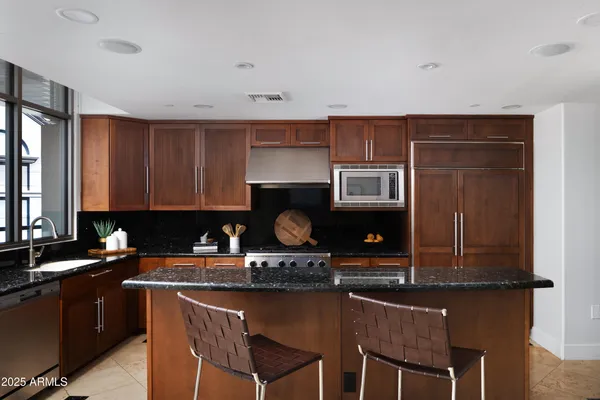 a kitchen with granite countertop a sink and a stove