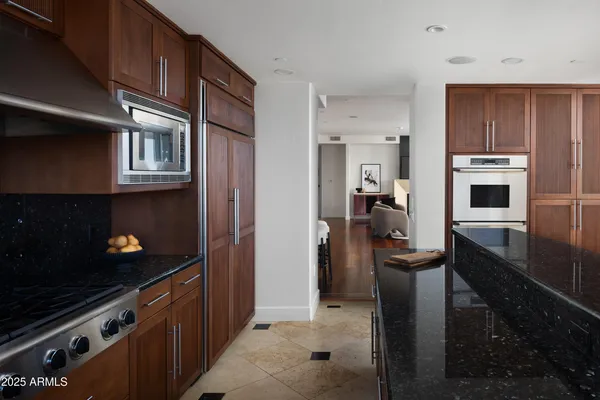 a kitchen with cabinets and steel stainless steel appliances