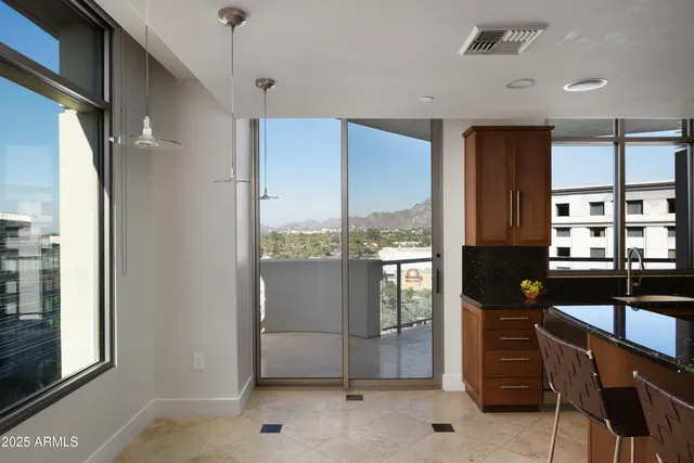 a view of a hallway and a livingroom with furniture