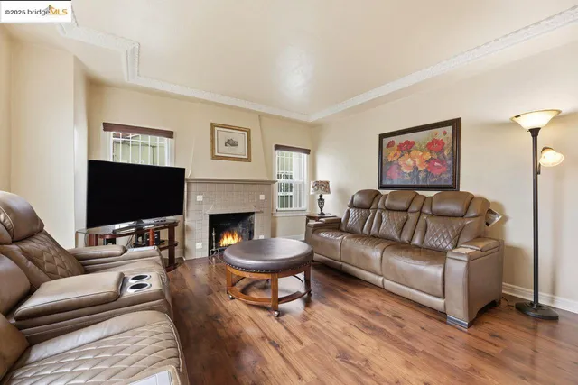 a living room with furniture a flat screen tv and a fireplace