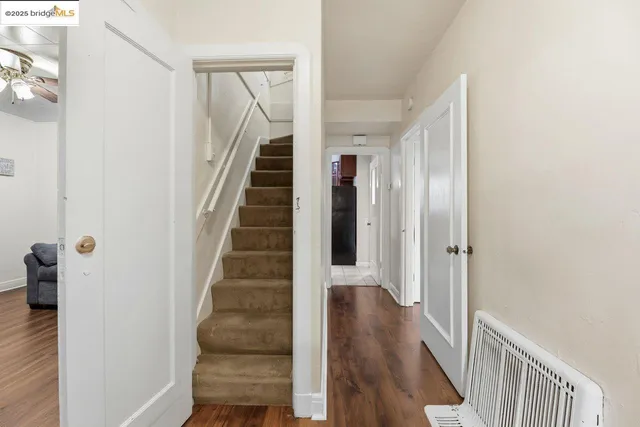 a view of a hallway with wooden floor and entryway