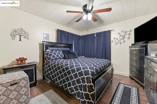 a bed room with a bed window and a flat screen tv