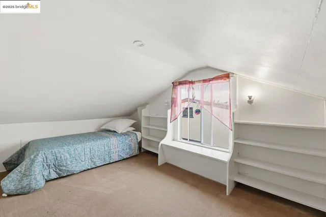 a spacious bedroom with a bed and a chandelier