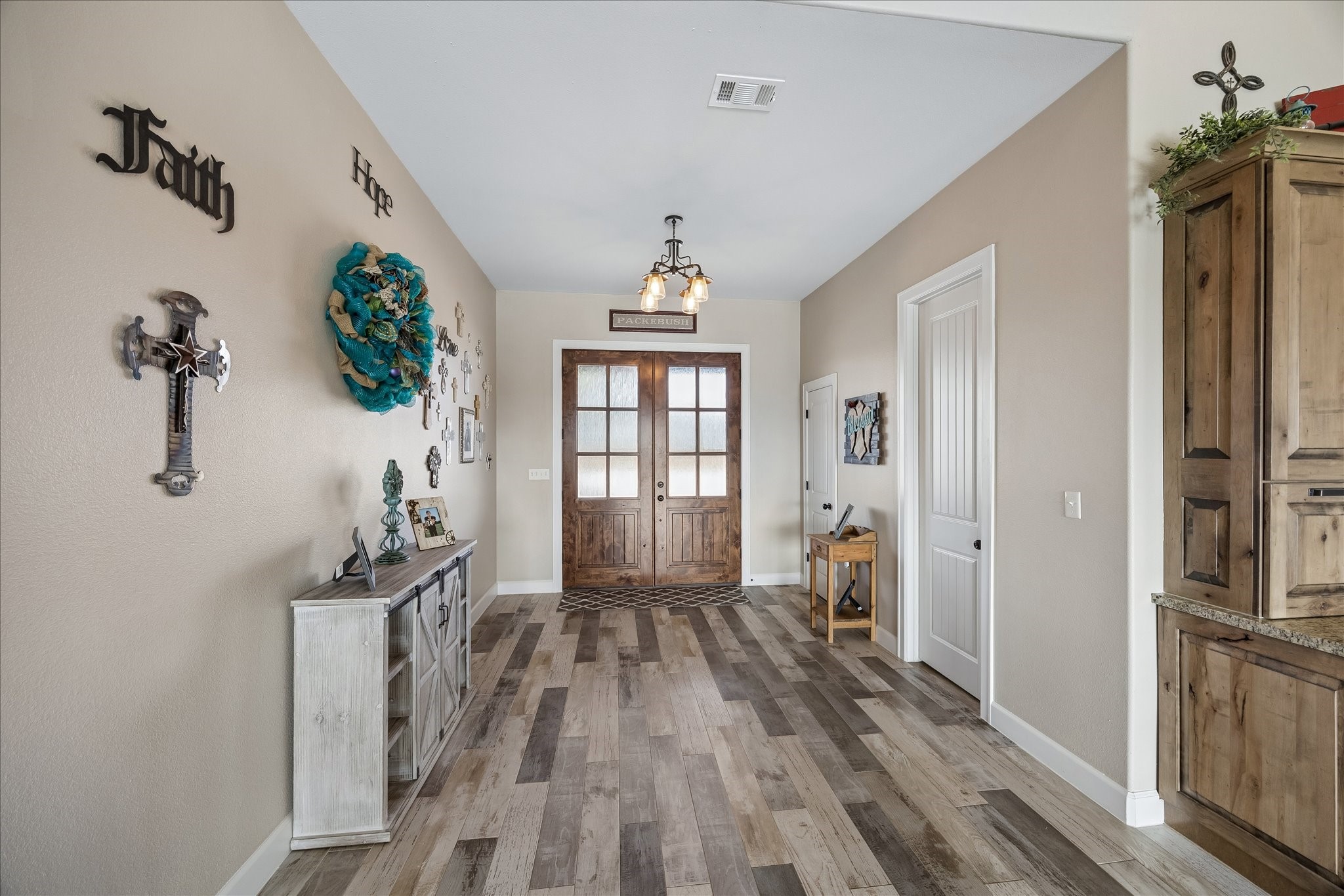 2224 Maler Road Sealy, TX 77474 - Photo 8 of 50 This welcoming entry way features a warm, rustic design with a beautifully stained wooden door and stylish tile flooring.