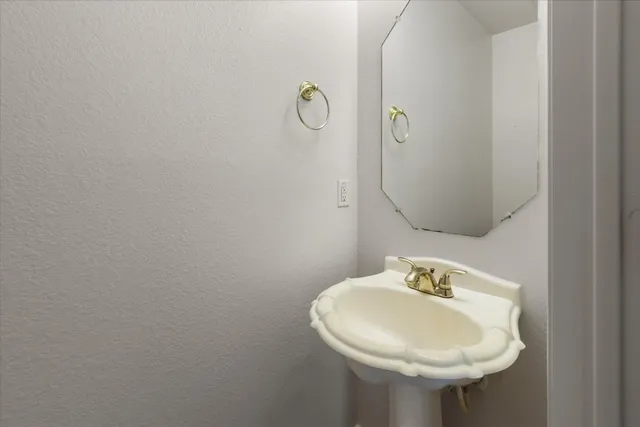 a bathroom with a sink and mirror