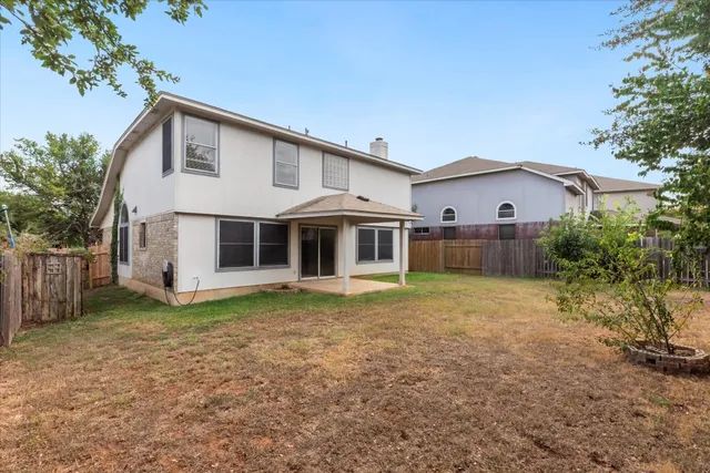 a view of a house with a yard and sitting area