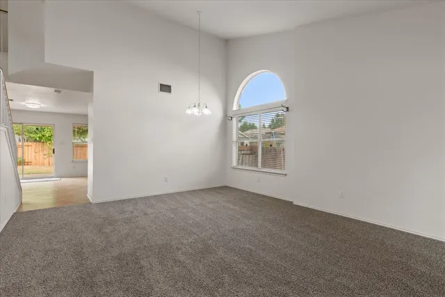 an empty room with windows and entrance