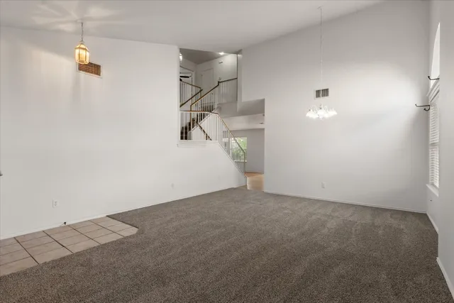 a view of a room with stairs and white walls