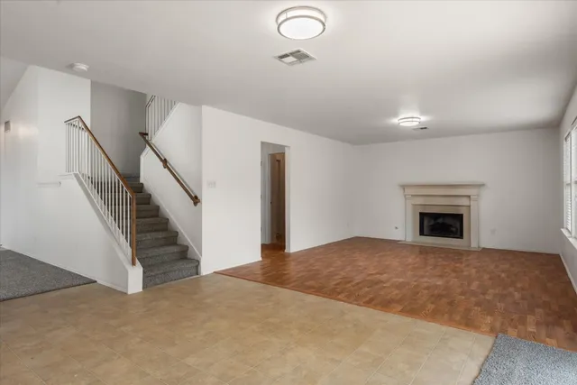 a view of a livingroom with an empty space and fireplace