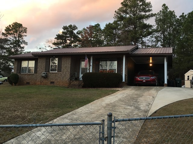 3512 Warpath Road Macon, GA 31217 - Photo 9 of 21 a front view of a house with a yard and garage