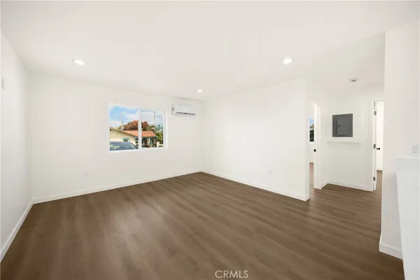 a view of a room with wooden floor and a window