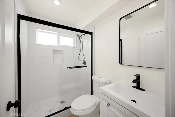 a kitchen with stainless steel appliances granite countertop a refrigerator sink and white cabinets