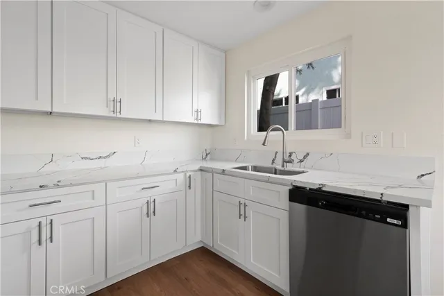 a kitchen with stainless steel appliances a refrigerator sink and cabinets