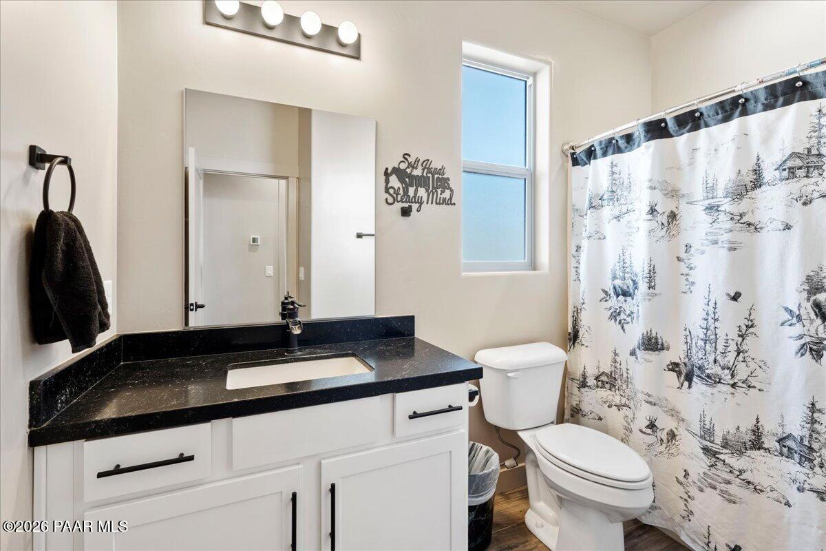 22367 North Malapai Ridge Road Paulden, AZ 86334 - Photo 14 of 23 a bathroom with a granite countertop sink toilet and shower