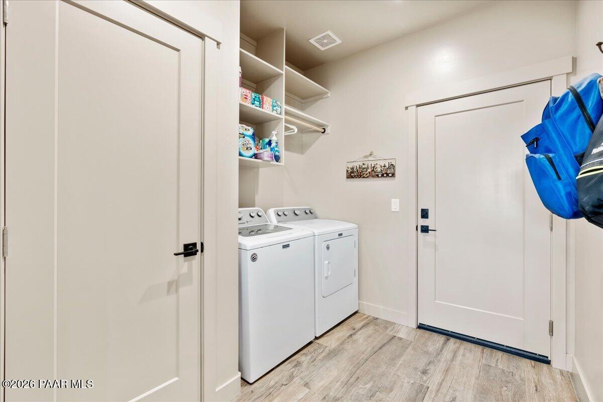 22367 North Malapai Ridge Road Paulden, AZ 86334 - Photo 8 of 23 a storage room with wooden floor and cabinets